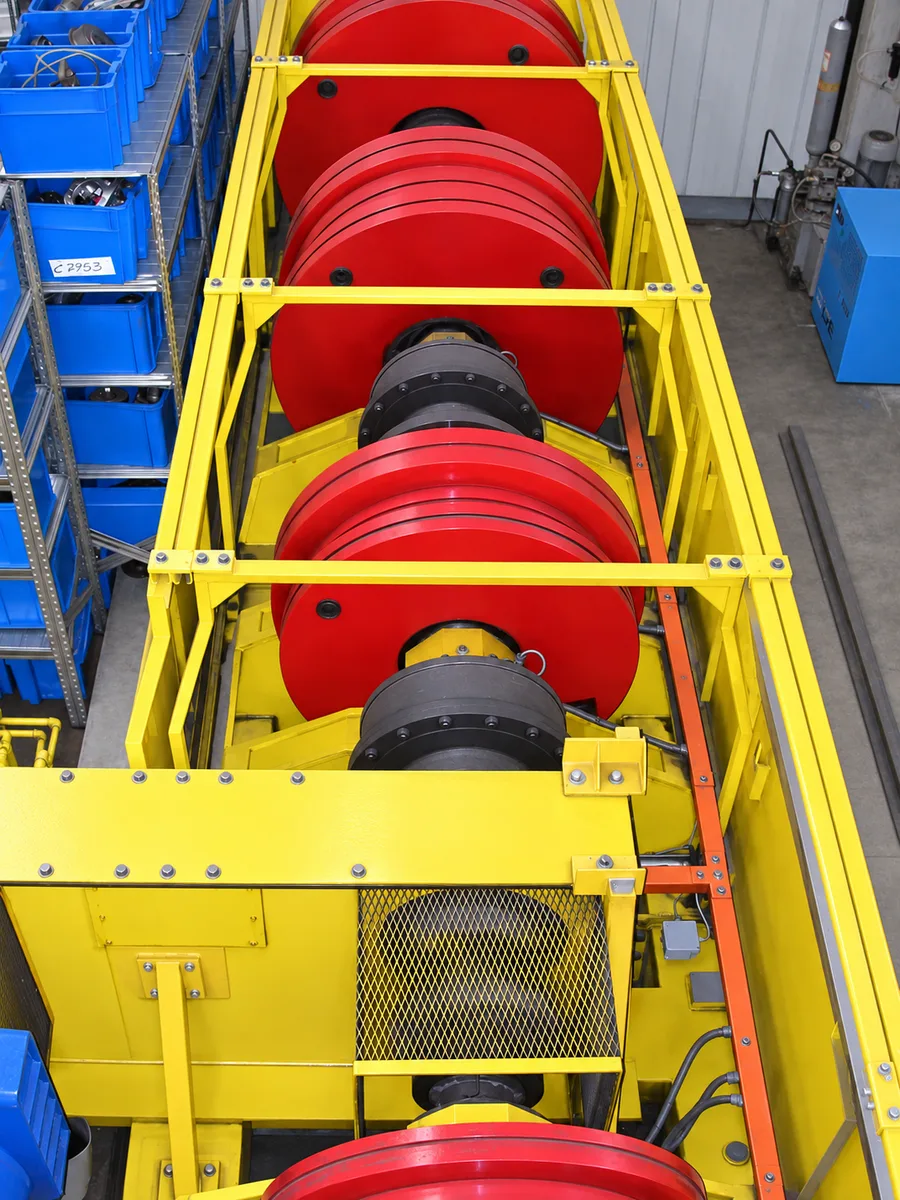 Red flywheel assembly in a yellow dynamometer frame
